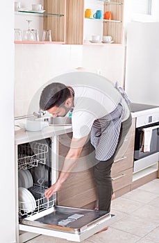 Man unloading dishwasher