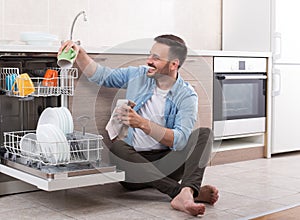 Man unloading dishwasher