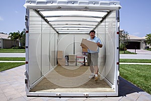 Man unloading portable storage unit photo