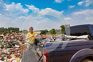 A man unloads his garbage from a pickup truck at a garbage dump in Paraguay.