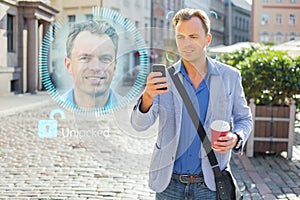 Man unlock his mobile phone with facial recognition and authentication technology