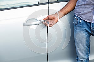 Man unlocks car door alarm systems with remote control. Vehicle convenience safety security system