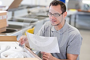 man unpacking box and reading instructions