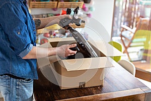 Man unpacking parcel with tools ordered online