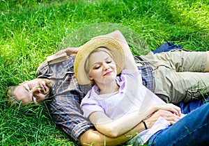 Man unshaven and girl lay on grass meadow. Guy and girl dreamy sleepy enjoy tranquility nature. Couple in love having