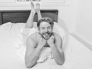 Man unshaven handsome happy smiling torso relaxing bed. Guy macho lay white bedclothes. Man feel full of energy