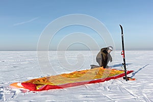 Man unwinding slings at kite on snow, Novosibirsk,Russia