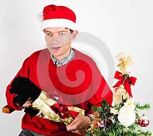 Man unwrapping a Christmas gift