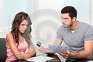 Man upset after looking at card statement.