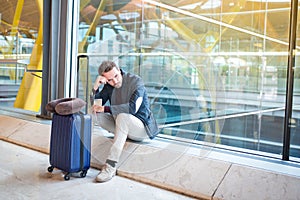 Man upset, sad and angry at the airport his flight is delayed