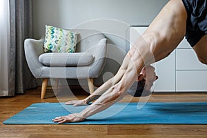 Man in upward dog pose doing vinyasa flow at home