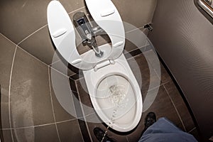 Man urinating in public restroom