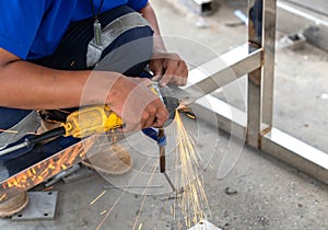The man use electric grinding stainless steel in workshop