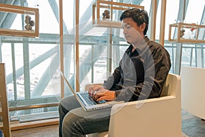 Man use laptop in airport lounge