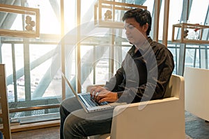 Man use laptop in airport lounge in morning time