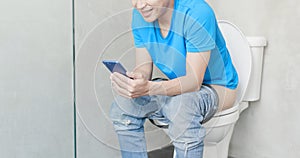 Man use phone on toilet