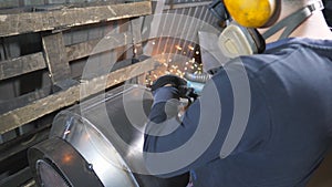 Man use saw cutting machine to cut metal detail. Unrecognizable guy with circular saw hard worked over the steel in