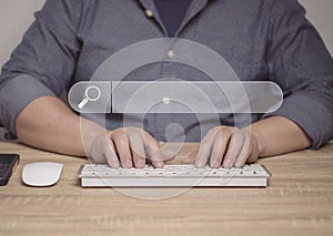 A man uses a computer to search for information through online search systems, technology, global information. online shopping