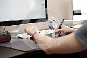Man uses graphics tablet. photo