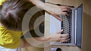 A man uses a laptop for distant work on a project. Work from home concept