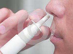 Man uses a nasal spray photo