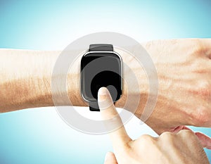 Man uses a smart watch on a blue background