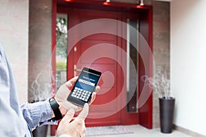 Man uses smartphone to open the door.