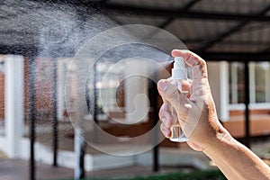 Man uses a spray of alcohol to get rid of bacteria and viruses