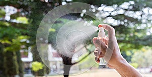 Man uses a spray of alcohol to get rid of bacteria and viruses