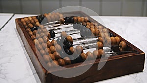 Man uses vintage old wooden abacus. Media. Close up of male hand counting with a USSR soviet old fashioned calculating