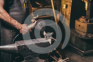 Man Using Angle Grinder in Factory and throwing sparks