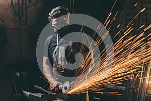 Man using angle grinder sparks