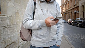 Man using app on smart phone in old city.