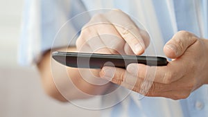 A man using apps on a mobile touchscreen smartphone