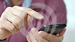 A man using apps on a mobile touchscreen smartphone