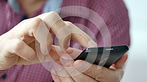 A man using apps on a mobile touchscreen smartphone