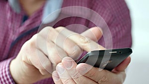 A man using apps on a mobile touchscreen smartphone