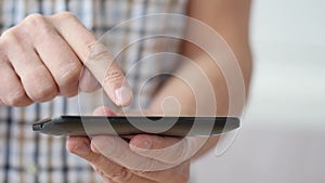 A man using apps on a mobile touchscreen smartphone