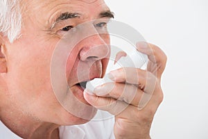 Man Using Asthma Inhaler