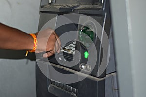 Man using ATM machine to withdraw his money. closeup of hand entering PIN or pass code on ATM machine keypad,security code on