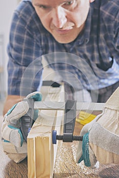 Man using bar clamp in a warkshop