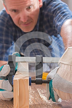 Man using bar clamp in a warkshop