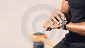 Man using black smart watch, checking heart rate