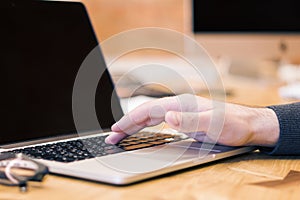 Man using blank laptop screen on desktop