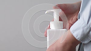 Man using a bottle of antibacterial disinfectant soap, hygiene prevention of an outbreak of the crown virus. Prevention