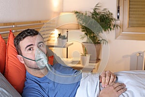 Man using breathing mask in bed