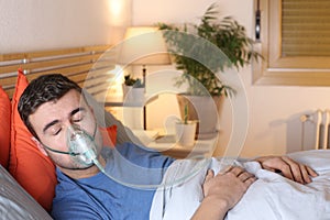 Man using breathing mask in bed