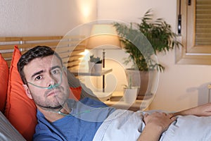 Man using breathing mask in bed