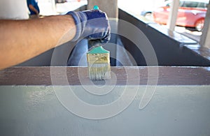 Man using a brush to paint a swimming pool photo