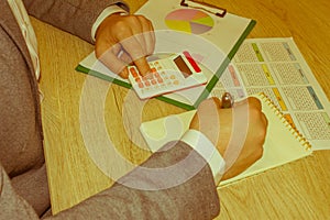 The Man are using a calculator on the table in the office room. accounting and business concept